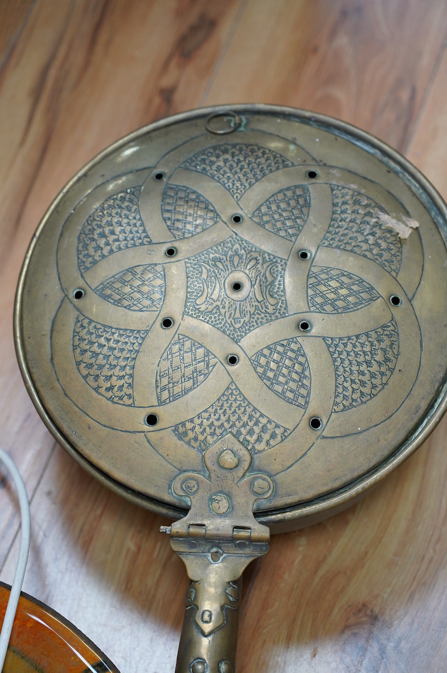 An Art Deco glass light shade, 40cm diameter, and an embossed brass warming pan, 194cm long. Condition - poor to fair